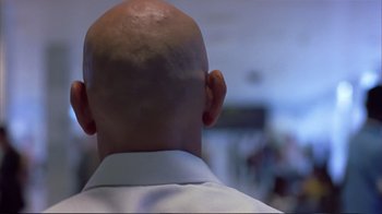 Movie still from “Sexy Beast” (2000), directed by Jonathan Glazer – A bald man with a shaved head is seen from the back; Close Up shot, Low angle