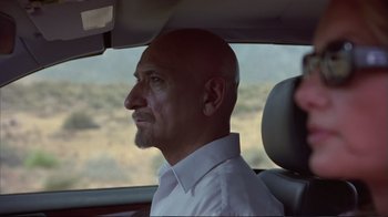 Movie still from “Sexy Beast” (2000), directed by Jonathan Glazer – A man sitting in the passenger seat of a car; Close Up shot, Over the shoulder angle