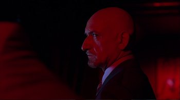 Movie still from “Sexy Beast” (2000), directed by Jonathan Glazer – A man with bald head wearing a suit and tie; Close Up shot, Low angle