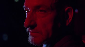 Movie still from “Sexy Beast” (2000), directed by Jonathan Glazer – A man's face in the dark; Close Up shot, Low angle