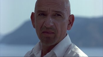 Movie still from “Sexy Beast” (2000), directed by Jonathan Glazer – A man with a bald head wearing a white shirt; Close Up shot, Low angle