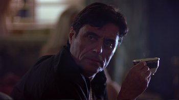 Movie still from “Sexy Beast” (2000), directed by Jonathan Glazer – A person holding a cell phone; Close Up shot, Low angle