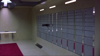 Movie still from “Sexy Beast” (2000), directed by Jonathan Glazer – A room with a skateboard ramp in the middle of the wall; Extreme Wide shot, High angle