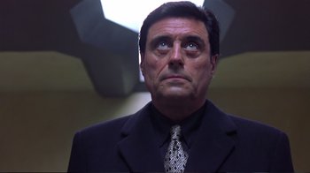 Movie still from “Sexy Beast” (2000), directed by Jonathan Glazer – A person wearing a suit and tie; Close Up shot, Low angle