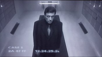 Movie still from “Sexy Beast” (2000), directed by Jonathan Glazer – A black and white photo of a man wearing a suit and tie; Medium shot, Low angle