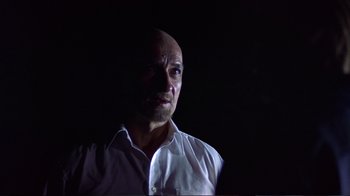 Movie still from “Sexy Beast” (2000), directed by Jonathan Glazer – A man with a bald head wearing a white shirt; Close Up shot, Low angle