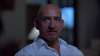 Movie still from “Sexy Beast” (2000), directed by Jonathan Glazer – A man with a bald head wearing a white shirt; Close Up shot, Low angle