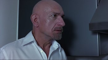 Movie still from “Sexy Beast” (2000), directed by Jonathan Glazer – A bald man with a shaved head and a white shirt; Close Up shot, Low angle