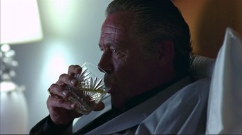 Movie still from “Sexy Beast” (2000), directed by Jonathan Glazer – A person drinking a glass of water; Close Up shot, Low angle
