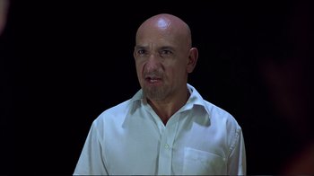 Movie still from “Sexy Beast” (2000), directed by Jonathan Glazer – A bald man in a white dress shirt; Close Up shot, Low angle