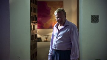 Movie still from “Sexy Beast” (2000), directed by Jonathan Glazer – An older man standing in front of an open door; Medium shot, Over the shoulder angle