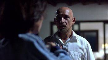 Movie still from “Sexy Beast” (2000), directed by Jonathan Glazer – An older man with a bald head talking to a younger man; Close Up shot, Over the shoulder angle