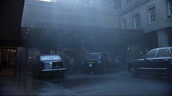 Movie still from “Sexy Beast” (2000), directed by Jonathan Glazer – Cars parked on the side of the road in the rain; Extreme Wide shot, Low angle