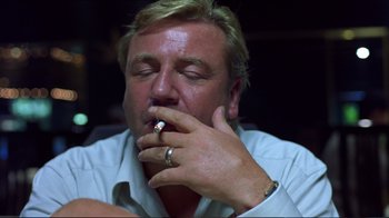 Movie still from “Sexy Beast” (2000), directed by Jonathan Glazer – A person holding a cigarette in his mouth; Close Up shot, Low angle