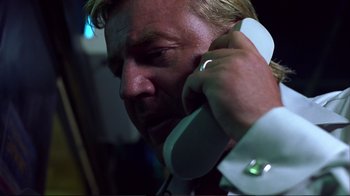 Movie still from “Sexy Beast” (2000), directed by Jonathan Glazer – A person talking on a phone; Close Up shot, Low angle