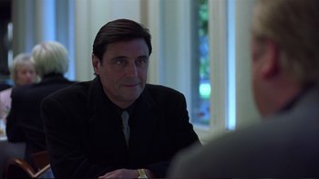 Movie still from “Sexy Beast” (2000), directed by Jonathan Glazer – A person wearing a suit and tie; Close Up shot, Over the shoulder angle