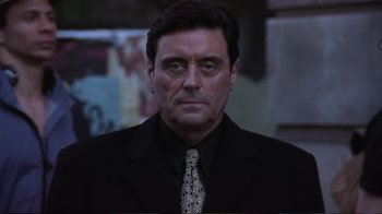 Movie still from “Sexy Beast” (2000), directed by Jonathan Glazer – A person wearing a suit and tie; Close Up shot, Low angle