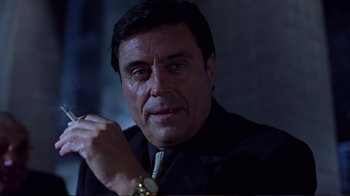 Movie still from “Sexy Beast” (2000), directed by Jonathan Glazer – A person wearing a suit and tie; Close Up shot, Low angle