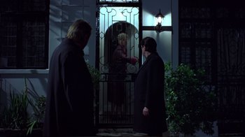 Movie still from “Sexy Beast” (2000), directed by Jonathan Glazer – Two people standing in front of an open door; Wide shot, Over the shoulder angle