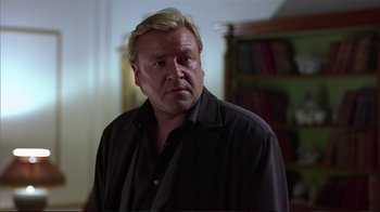 Movie still from “Sexy Beast” (2000), directed by Jonathan Glazer – A person wearing a black shirt; Close Up shot, Over the shoulder angle