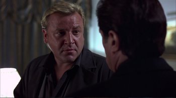 Movie still from “Sexy Beast” (2000), directed by Jonathan Glazer – A man looking at himself in the mirror; Close Up shot, Over the shoulder angle