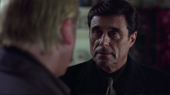 Movie still from “Sexy Beast” (2000), directed by Jonathan Glazer – A person looking at a mirror; Close Up shot, Over the shoulder angle