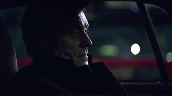 Movie still from “Sexy Beast” (2000), directed by Jonathan Glazer – A person in a car at night; Close Up shot, Low angle
