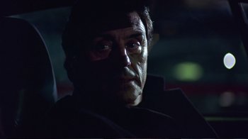 Movie still from “Sexy Beast” (2000), directed by Jonathan Glazer – A person wearing a coat; Close Up shot, Over the shoulder angle