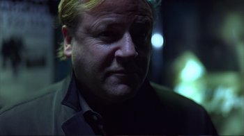 Movie still from “Sexy Beast” (2000), directed by Jonathan Glazer – A person wearing a suit and tie; Close Up shot, Low angle