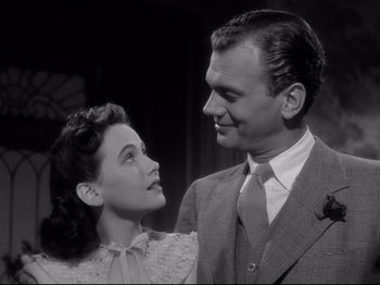 Movie still from “Shadow of a Doubt” (1943), directed by Alfred Hitchcock – A man and a woman standing next to each other; Close Up shot, Low angle