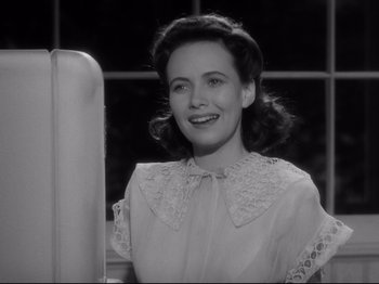 Movie still from “Shadow of a Doubt” (1943), directed by Alfred Hitchcock – A black - and - white photo of a woman smiling; Close Up shot, Low angle