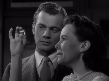 Movie still from “Shadow of a Doubt” (1943), directed by Alfred Hitchcock – A man and a woman looking at each other with a ring in their hand; Close Up shot, Low angle