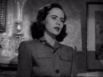 Movie still from “Shadow of a Doubt” (1943), directed by Alfred Hitchcock – An old photo of a young woman in a suit; Close Up shot, Low angle