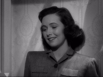 Movie still from “Shadow of a Doubt” (1943), directed by Alfred Hitchcock – An old photo of a woman smiling for the camera; Close Up shot, High angle
