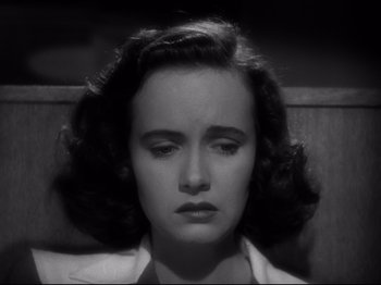 Movie still from “Shadow of a Doubt” (1943), directed by Alfred Hitchcock – A black - and - white photo of a woman with a sad look; Close Up shot, High angle