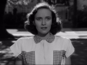 Movie still from “Shadow of a Doubt” (1943), directed by Alfred Hitchcock – An old photo of a young woman in a checkered shirt; Close Up shot, Low angle