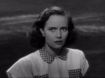 Movie still from “Shadow of a Doubt” (1943), directed by Alfred Hitchcock – An old photo of a young woman in a plaid shirt; Close Up shot, High angle