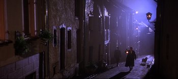 A man walking down a street at night