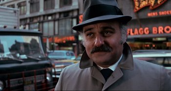 Movie still from “Shaft” (1971), directed by Gordon Parks – A person wearing a hat and a coat; Close Up shot, Low angle