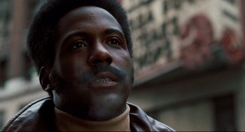 Movie still from “Shaft” (1971), directed by Gordon Parks – A person wearing a leather jacket; Close Up shot, Low angle