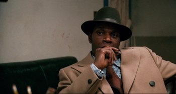 Movie still from “Shaft” (1971), directed by Gordon Parks – A man wearing a hat and a jacket; Close Up shot, Over the shoulder angle
