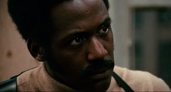Movie still from “Shaft” (1971), directed by Gordon Parks – A person with a mustache; Close Up shot, Low angle