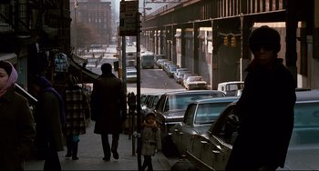 Movie still from “Shaft” (1971), directed by Gordon Parks – A woman and a child walking down the sidewalk; Wide shot, Over the shoulder angle