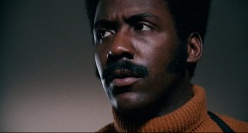Movie still from “Shaft” (1971), directed by Gordon Parks – A person wearing a sweater; Close Up shot, Low angle