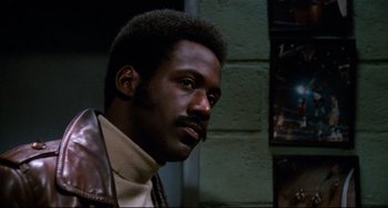 Movie still from “Shaft” (1971), directed by Gordon Parks – A person wearing a leather jacket; Close Up shot, Low angle