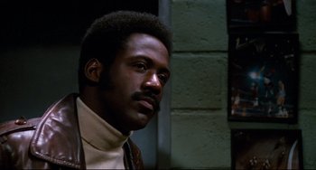 Movie still from “Shaft” (1971), directed by Gordon Parks – A person wearing a leather jacket; Close Up shot, Low angle