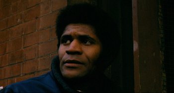 Movie still from “Shaft” (1971), directed by Gordon Parks – A person looking up at the sky; Close Up shot, Low angle