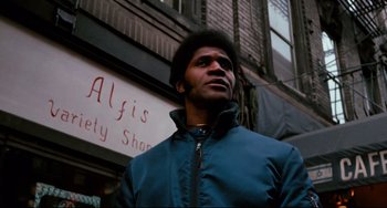 Movie still from “Shaft” (1971), directed by Gordon Parks – A man standing in front of a building in the city; Close Up shot, Low angle