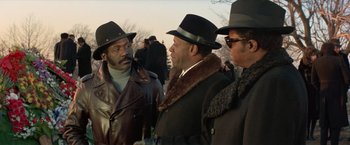 Movie still from “Shaft's Big Score!” (1972), directed by Gordon Parks – A group of men standing next to each other wearing hats; Medium shot, Low angle