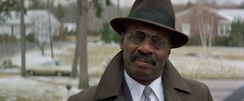 Movie still from “Shaft's Big Score!” (1972), directed by Gordon Parks – A person wearing a hat and sunglasses; Close Up shot, Low angle